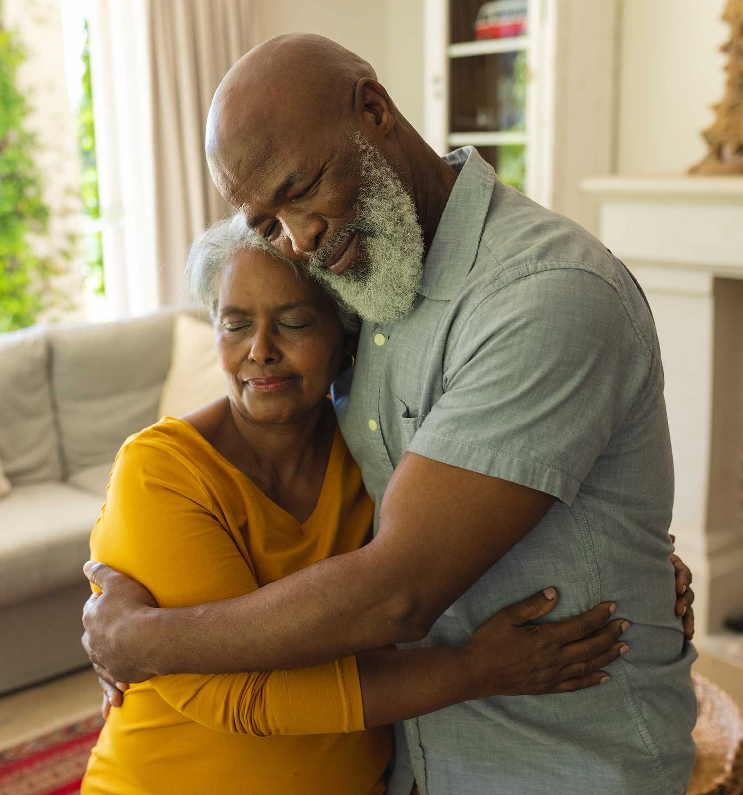 Elderly couple embracing at home, symbolizing comfort, dignity, and compassionate palliative care at St. Mary’s Hospice.
